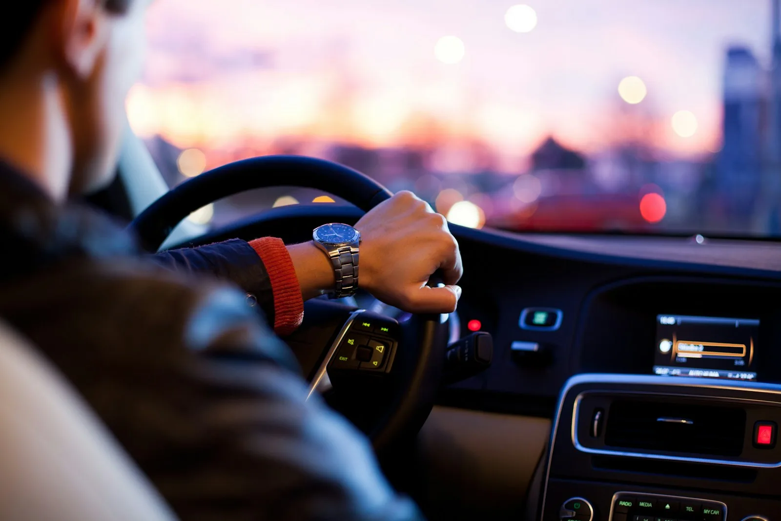 The picture highlights a men driving a car