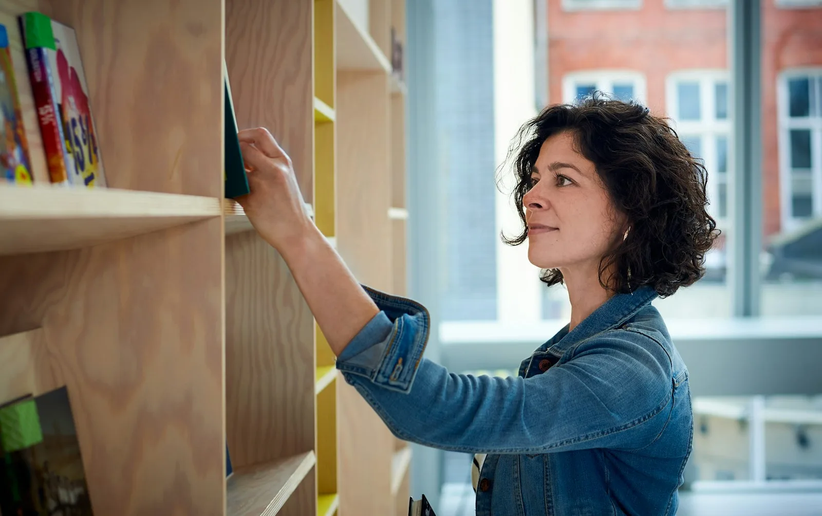 A lady working as a librarian to as a side hustle to increase her income stream