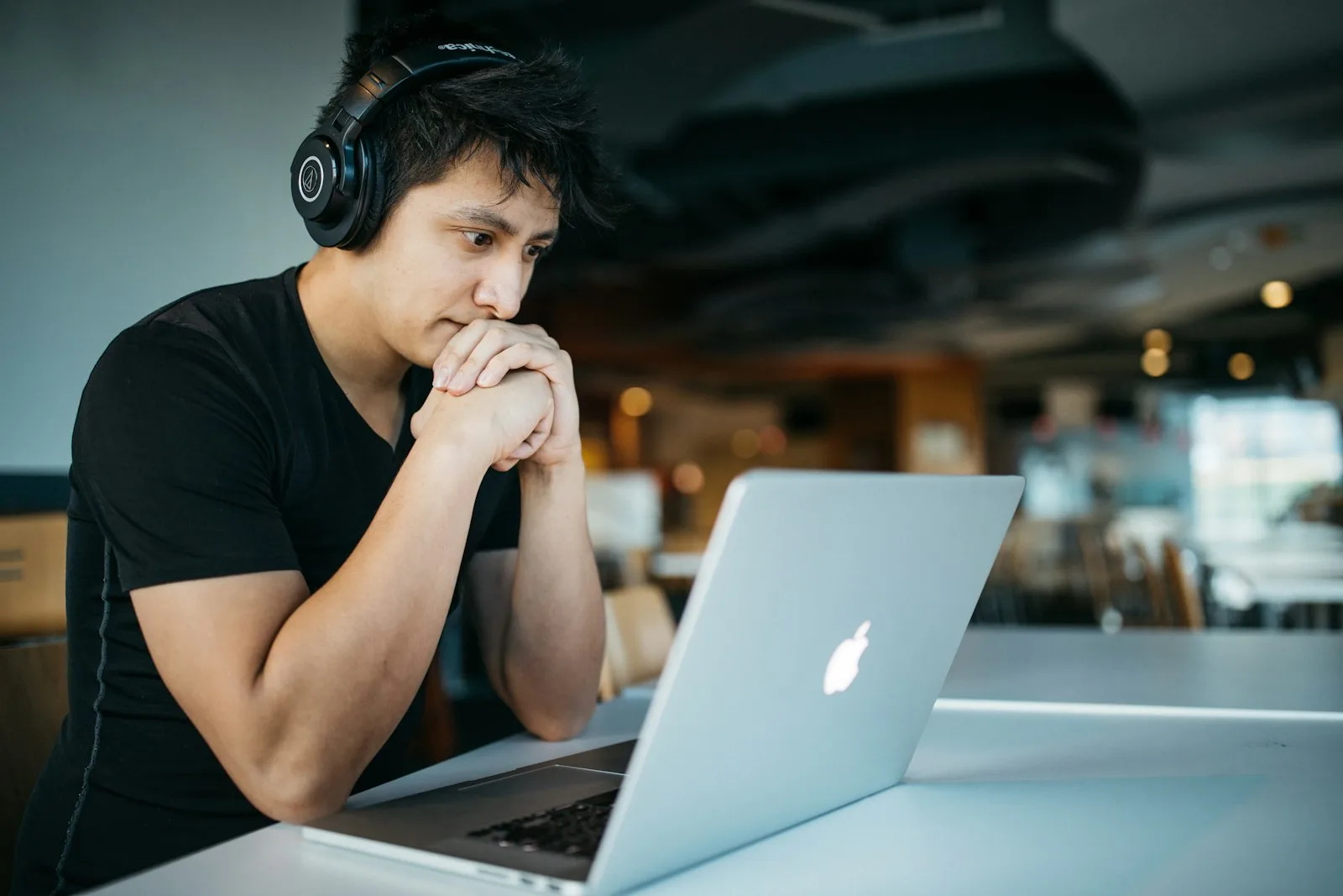 A college student looking at his own finances on a laptop