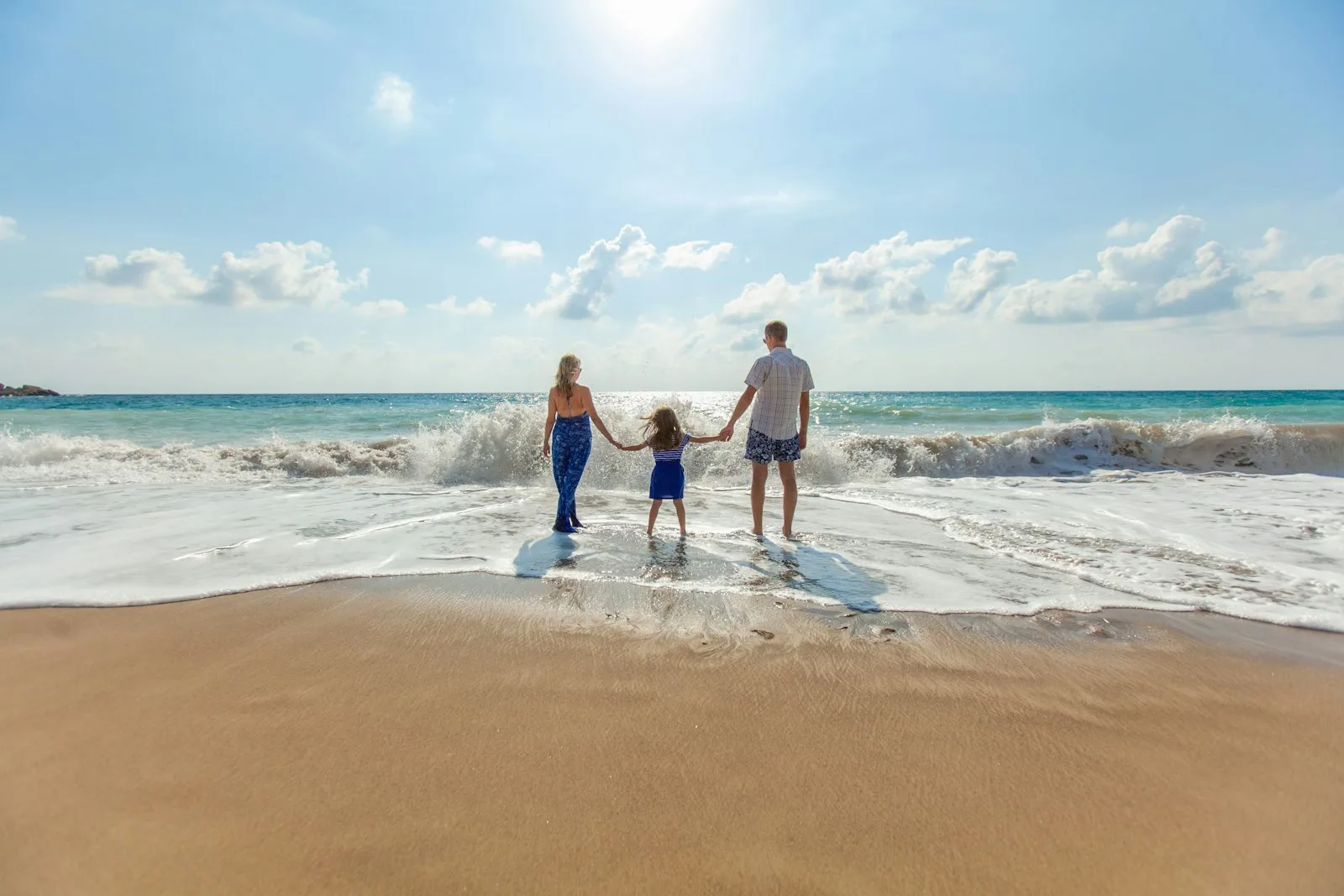 A family of three enjoying on the beach