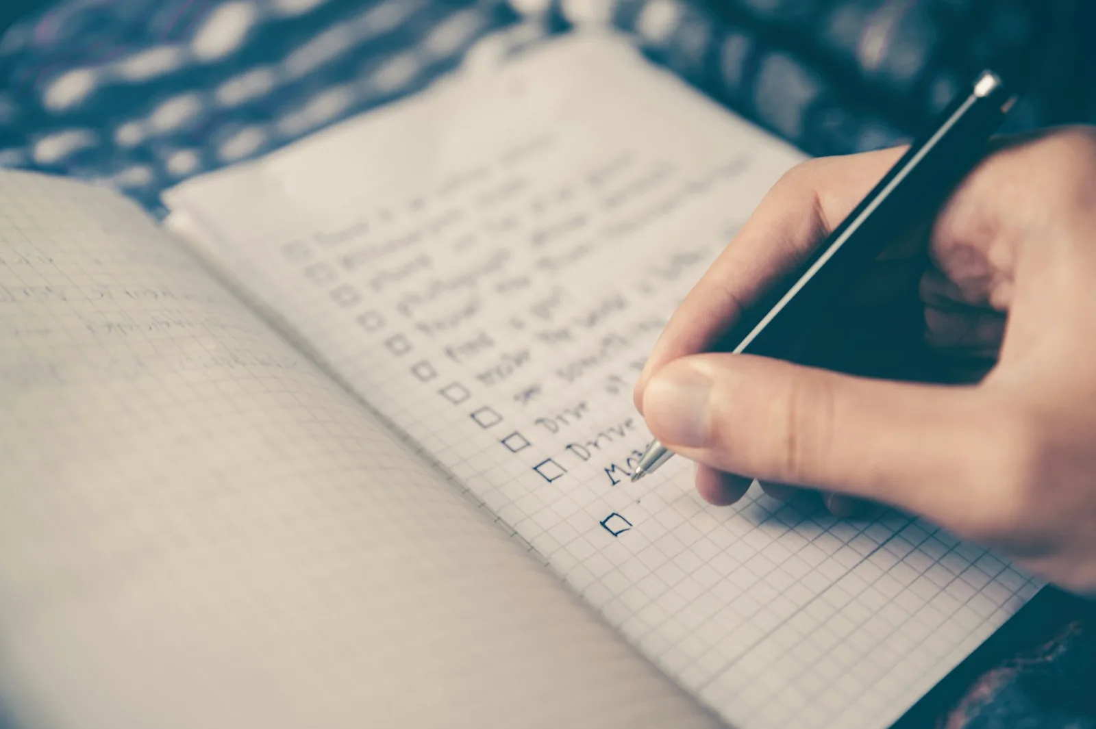 A college student making a financial plan in a notebook
