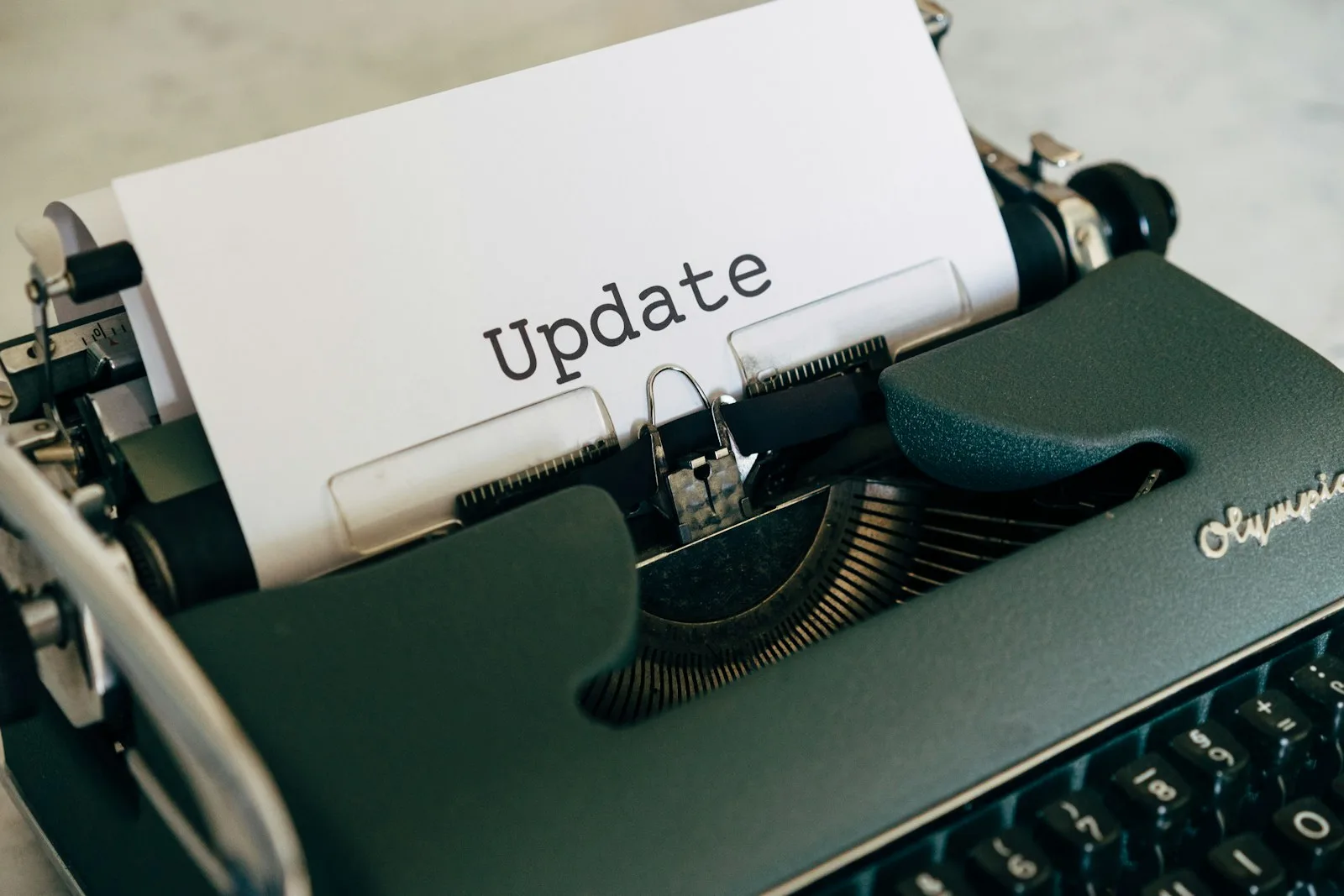 Image of a typewriter printing the word “Update”