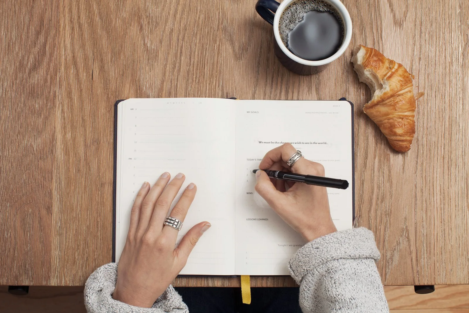 Photo of a person writing an action plan in a diary