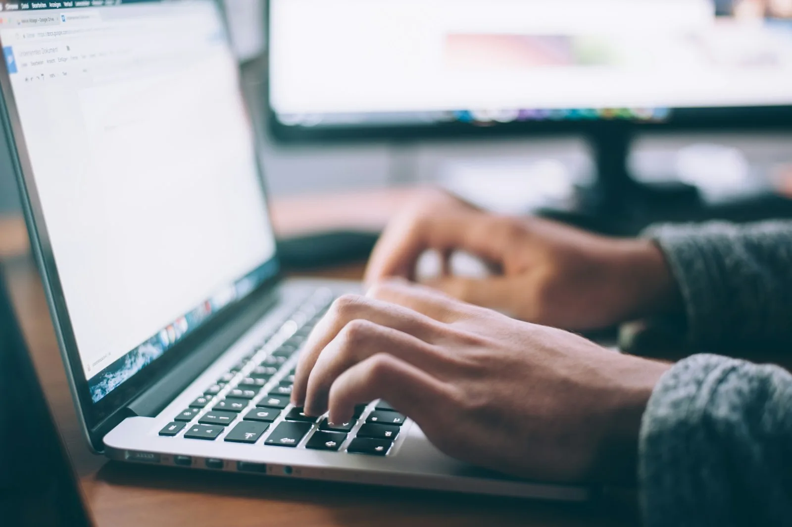 A person performing market research on a laptop