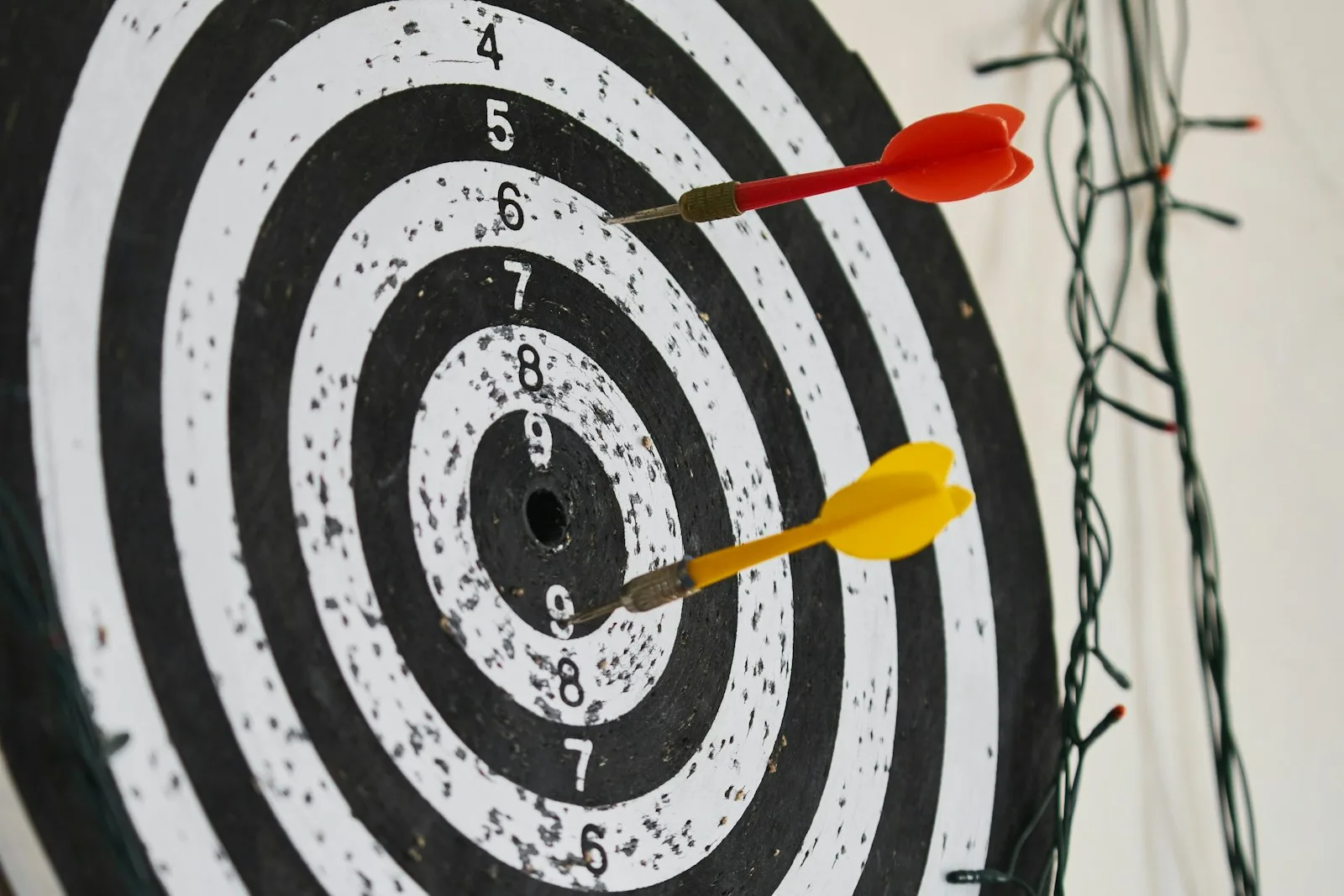 Image of a dart with scores written on it.