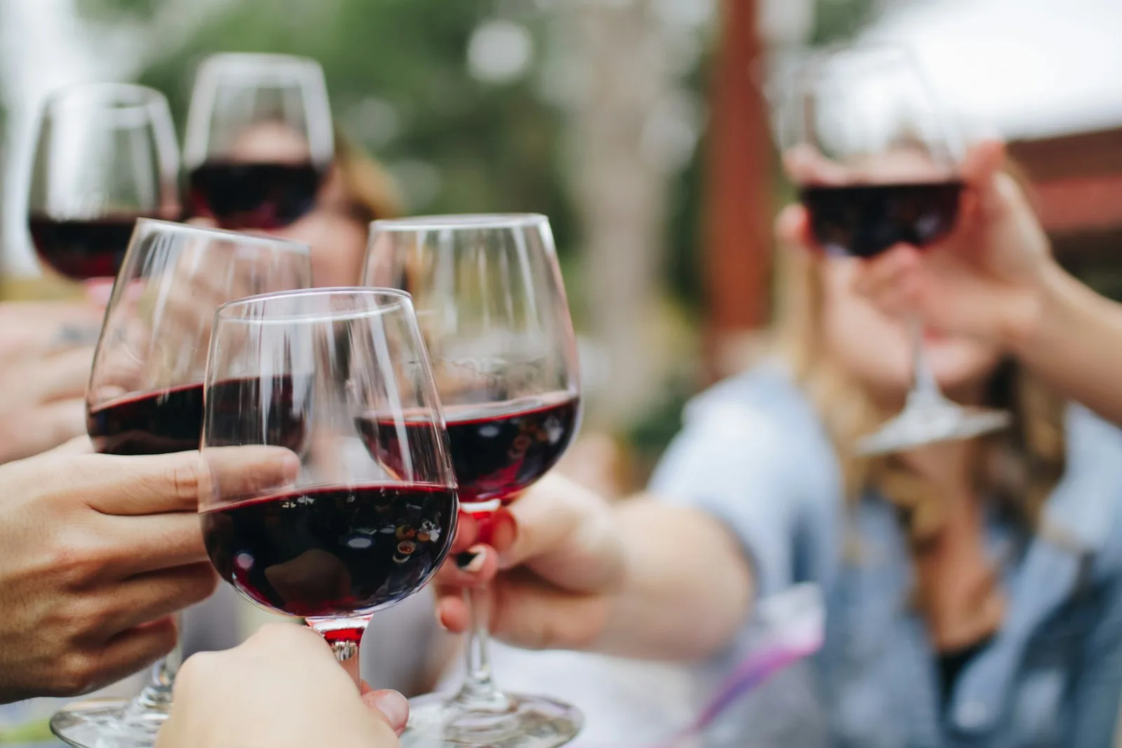 People celebrating and raising a toast with wine glasses