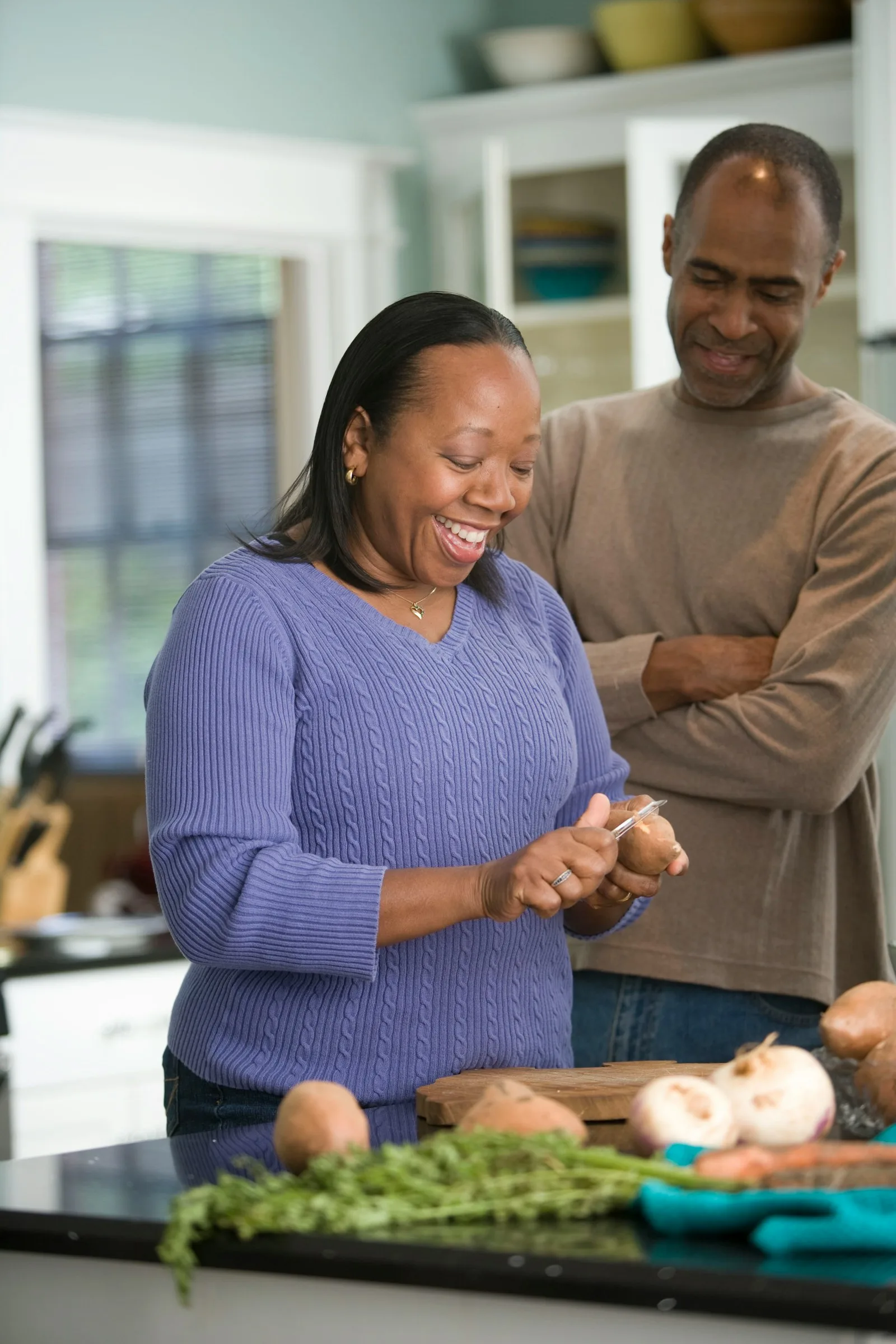A couple enjoying a dinner preparation during their early retirement phase
